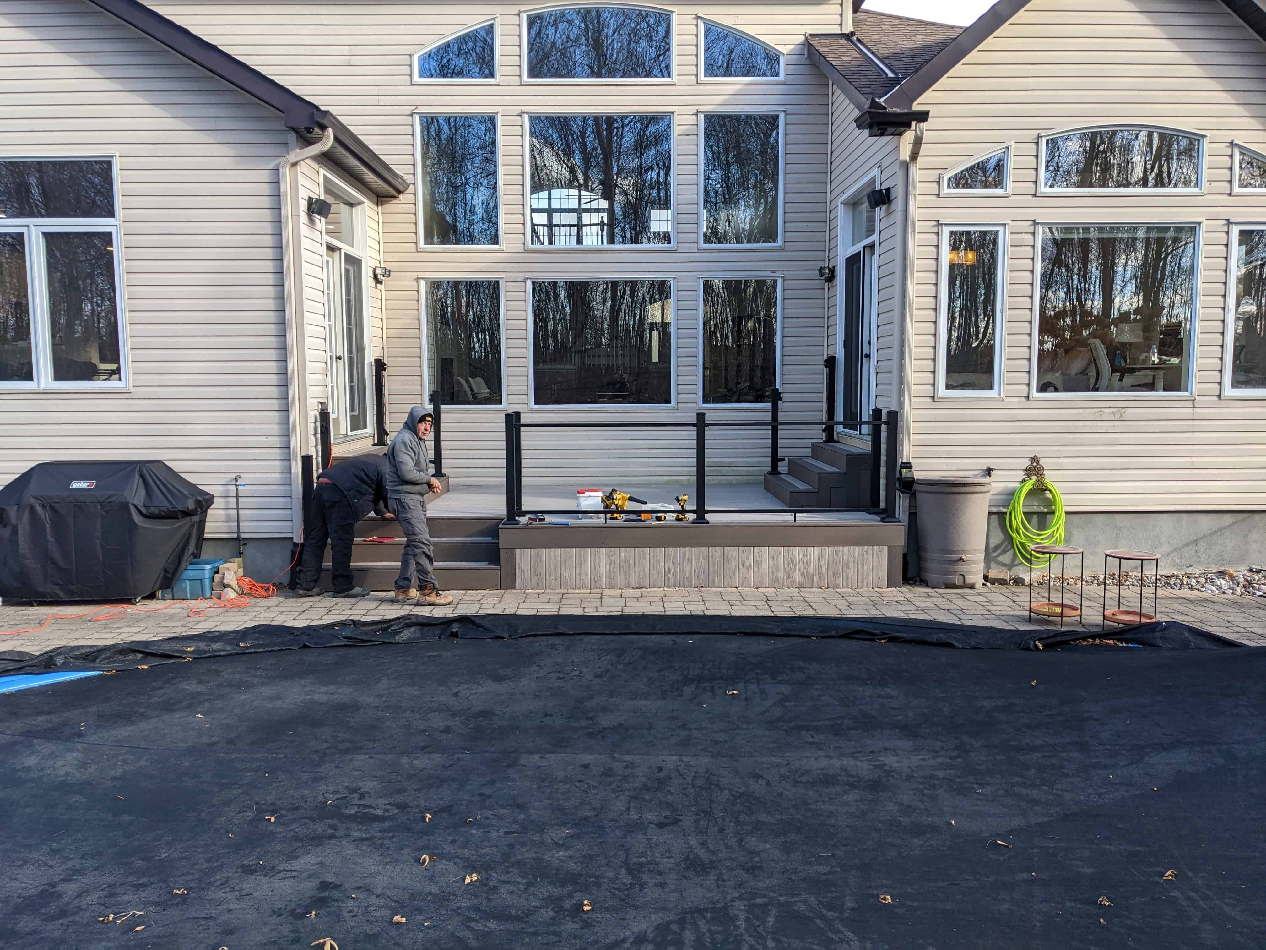 Composite poolside deck with glass railing in Ottawa