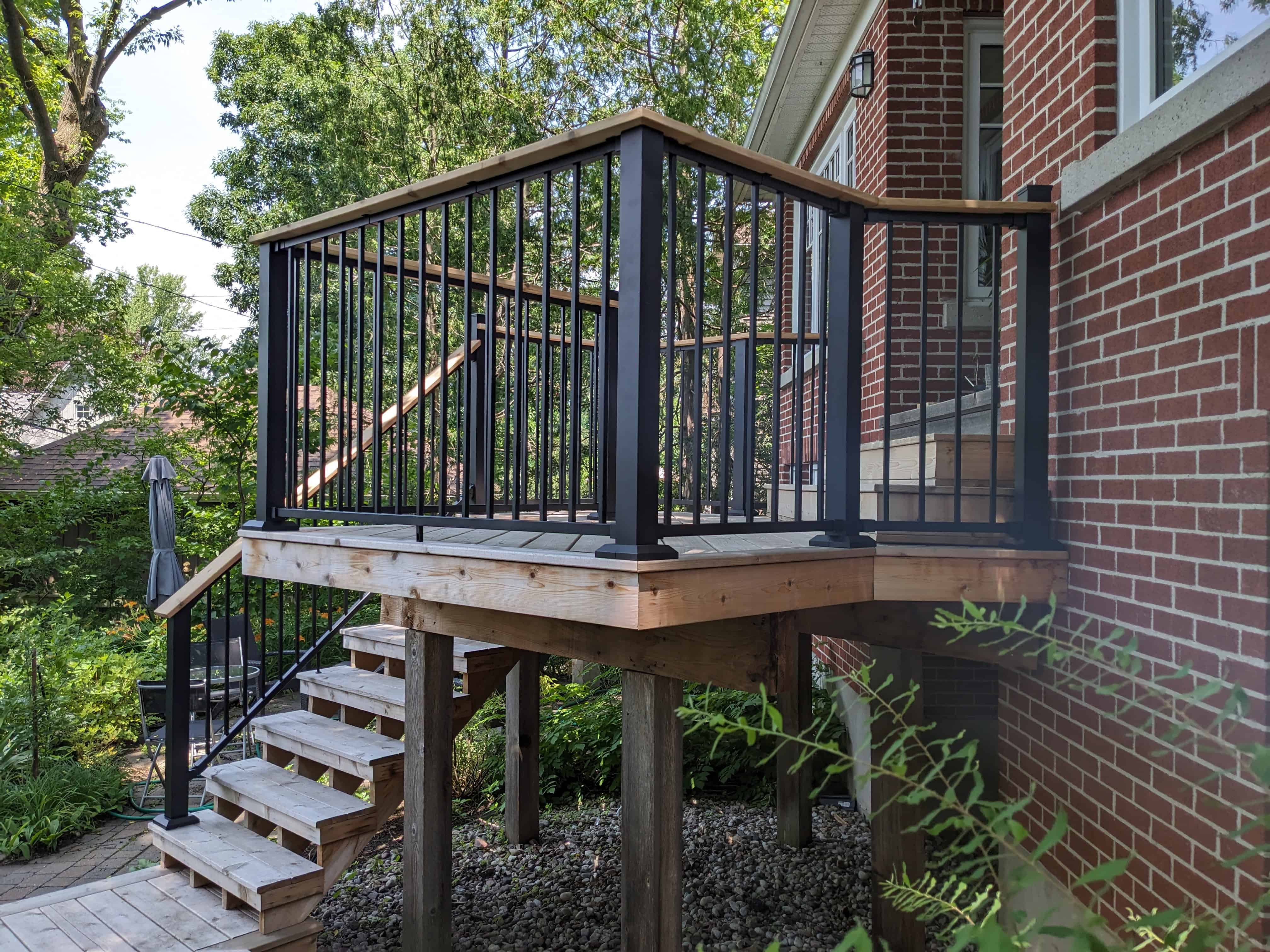 Fortress black railing with cedar drink rail on an Ottawa deck